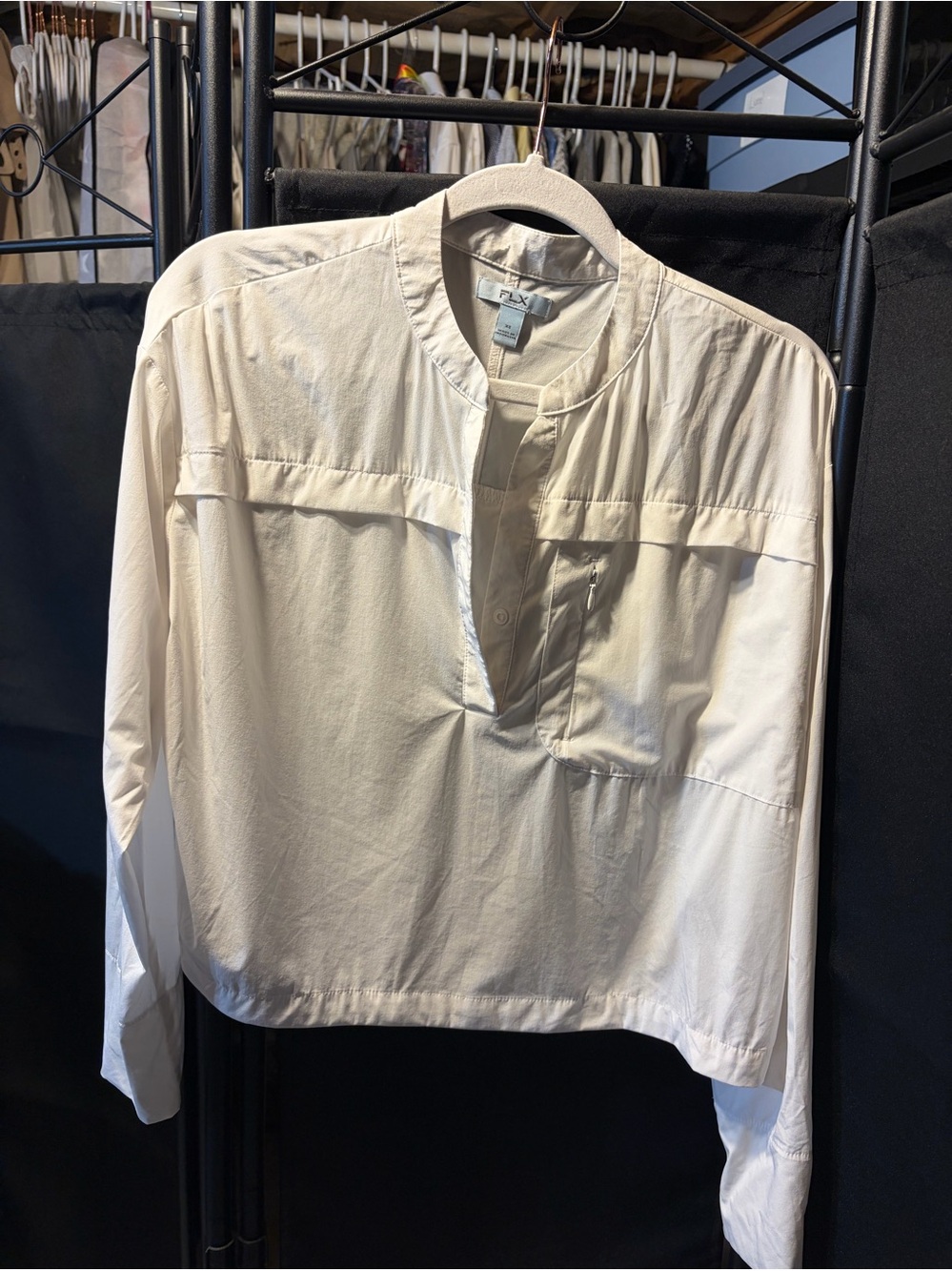 Creamy white lightweight pullover top from
FLX featuring a band collar
